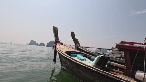 long-tail boats floating on a calm sea