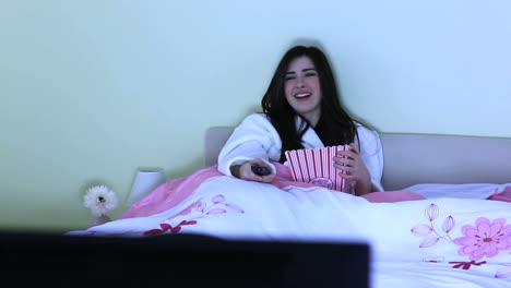 cheerful young woman watching television