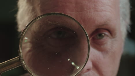 an older man looks through the loupe