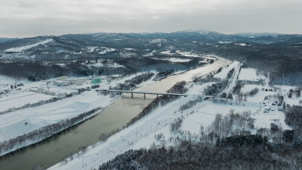 Winter Landscape Of Ishikari River Through Asahikawa City In Hokkaido, Northern Japan. Aerial Shot