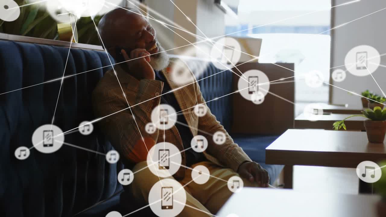 Man sitting in cafe on blue bench talking on smartphone, showing streaming icons with music notes