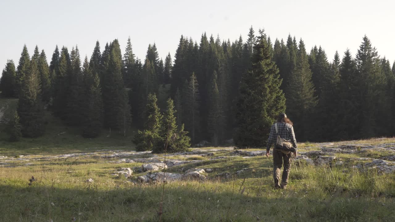 Hiker walking through a rocky clearing