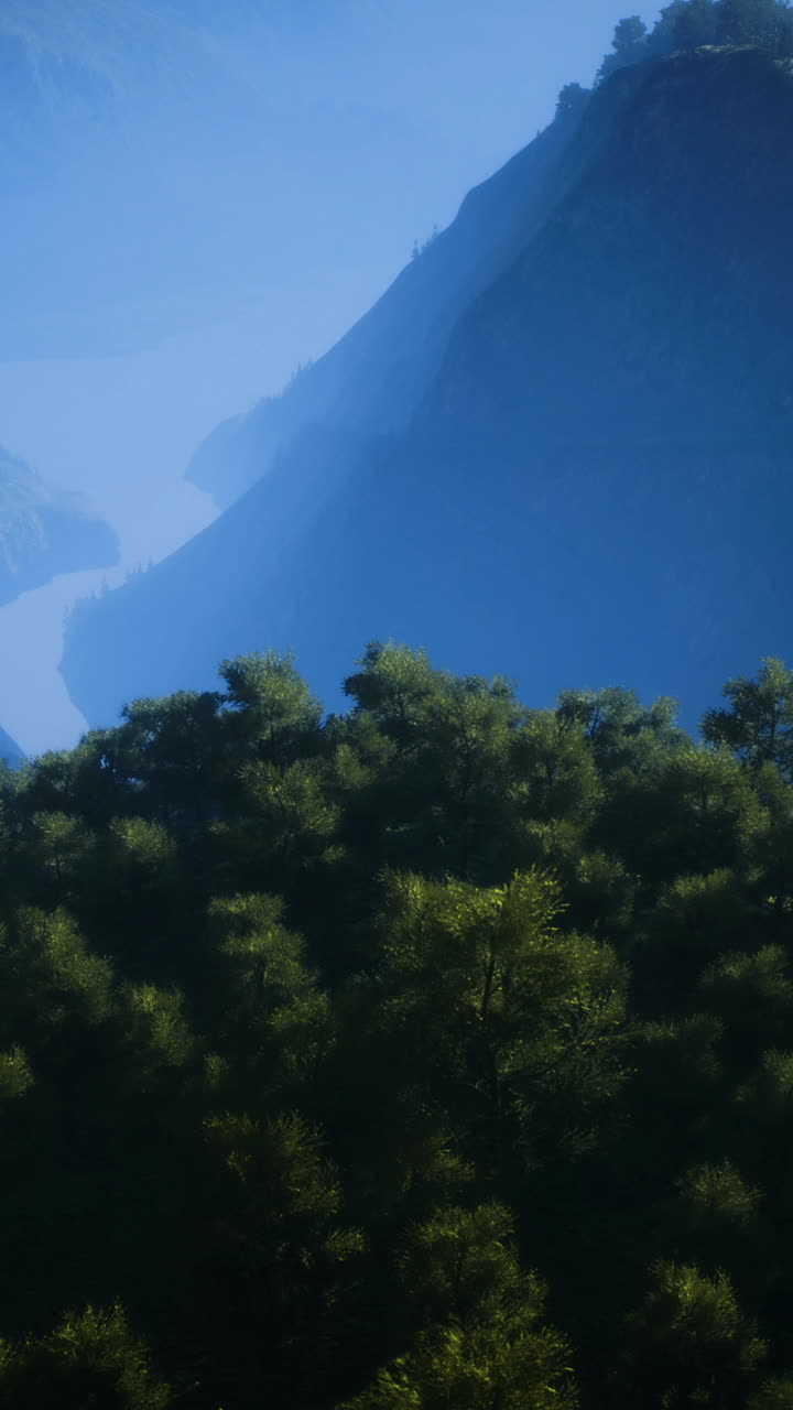 Morning light on majestic mountains and a river through lush valleys