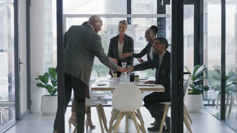 4k video footage of a group of businesspeople shaking hands during a meeting in an office