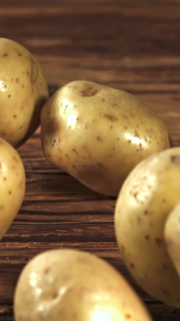 Primo piano di patate fresche e crude su un tavolo di legno rustico