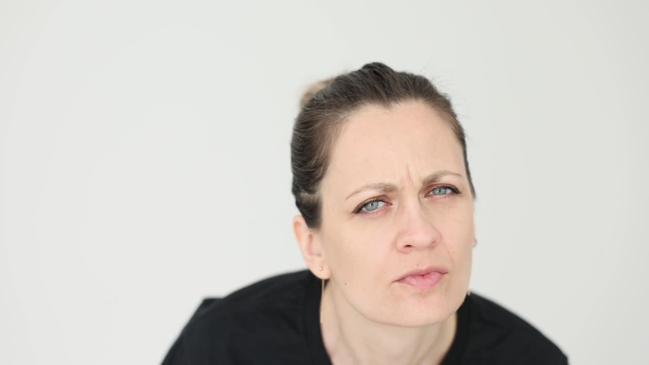 Close-up of a woman with a puzzled and questioning expression