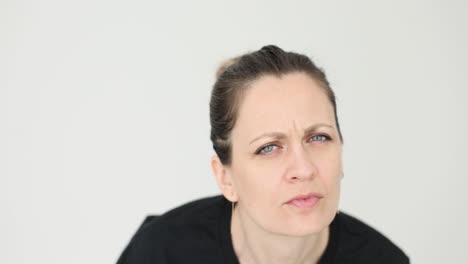 close-up of a woman with a puzzled and questioning expression