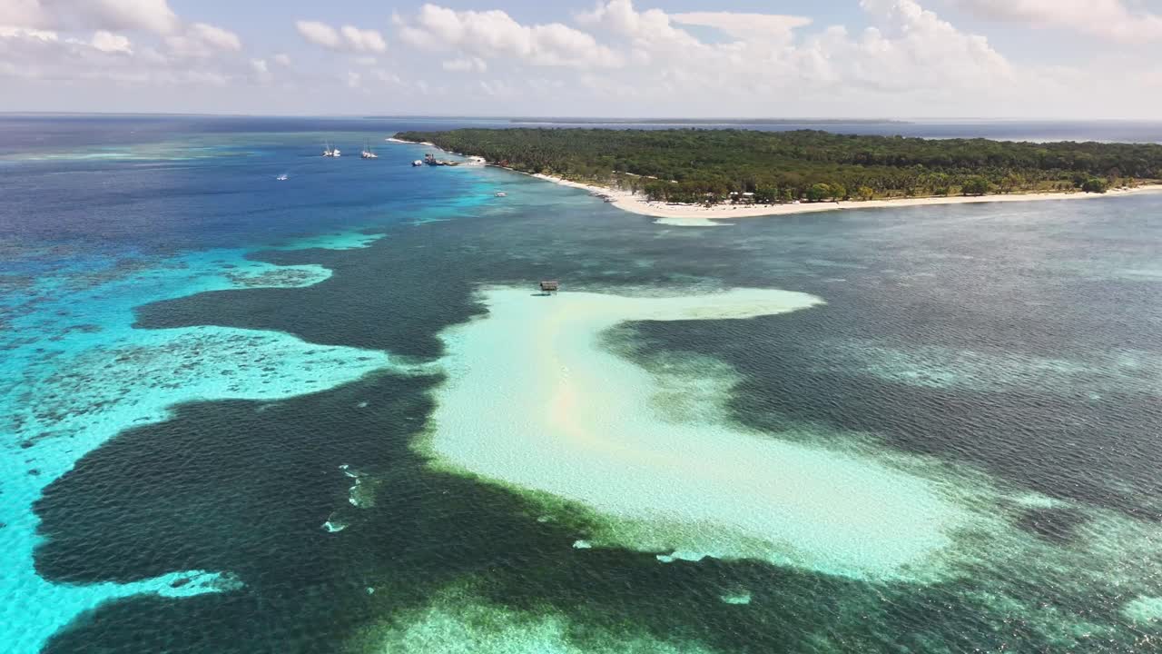 Drone captures Candaraman Sandbar off Balabac, Palawan, where white sandbanks gently curve into vivid turquoise waters framed by untouched forest and coral-rich shallows