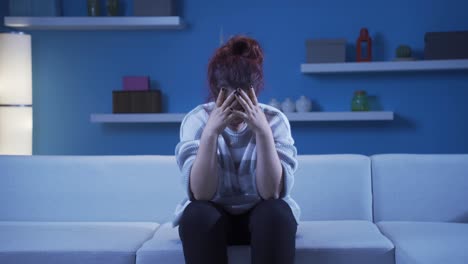 depressed woman covering her face with her hand.