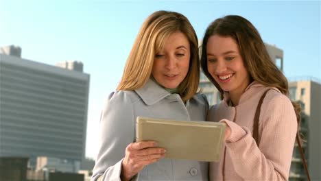 mother and daughter using their tablet