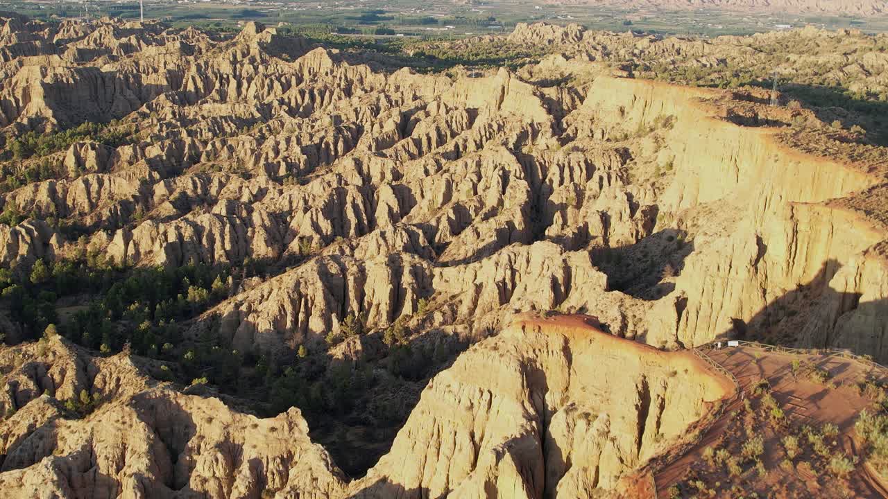 Mountainous desert landscape. Geology. erosion effect. Ravine and gullies at sunset, aerial view. Badlands. Climate change and desertification. Viewpoint of the end of the world