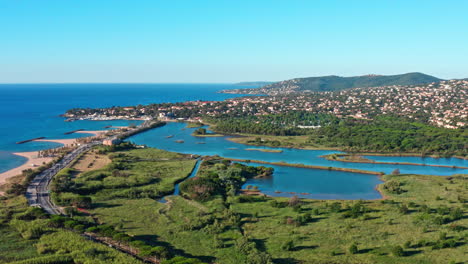 Aerial-shot-of-Saint-Aygulf-villepey-ponds-in-front-of-the-mediterranean-sea