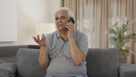 Indian-old-man-talking-on-phone