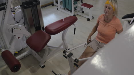 senior woman working out on exercise machine
