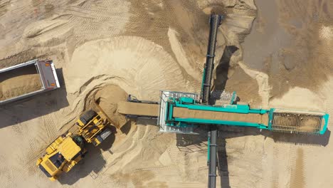 Aerial-view-loading-bulldozer-in-open-air-quarry