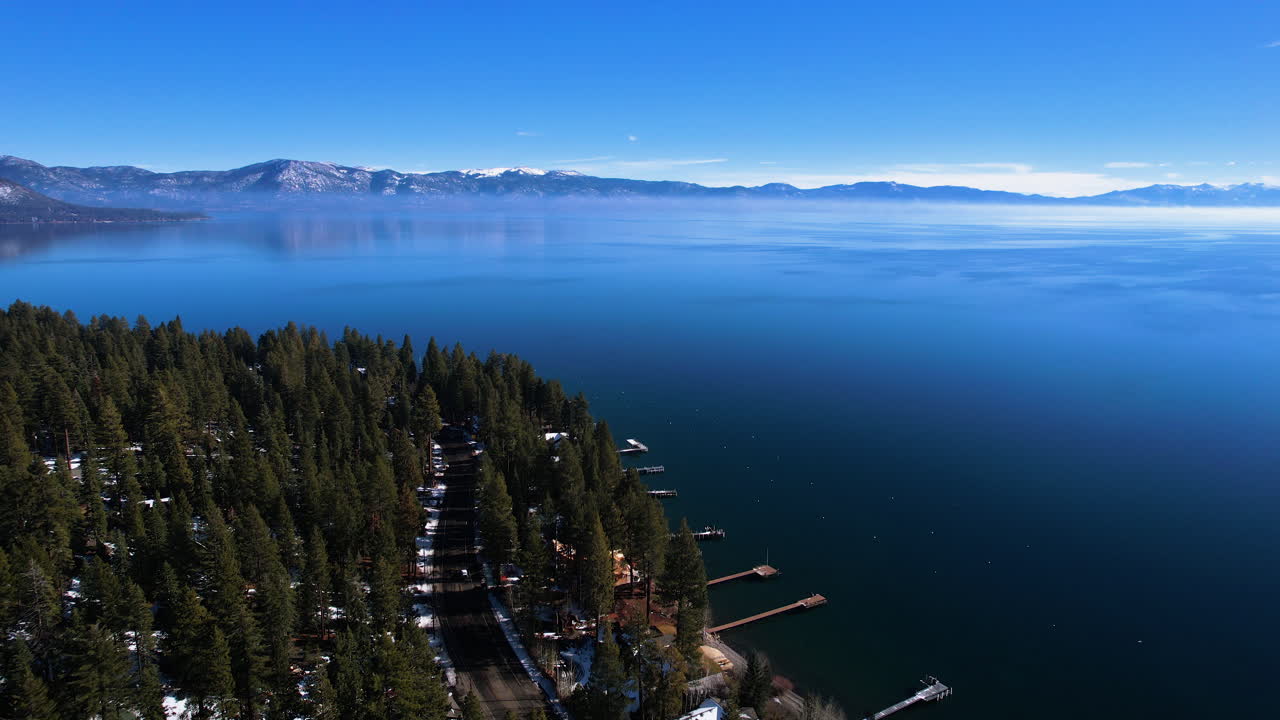 Aerial View of Lake Tahoe on Sunny Winter Day, Forest, Coastal Road and Blue Water, Nevada California Border USA