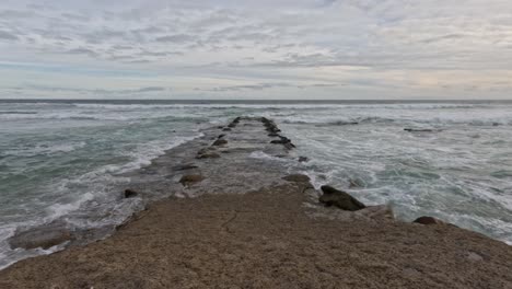 waves hitting rock path in melbourne, australia