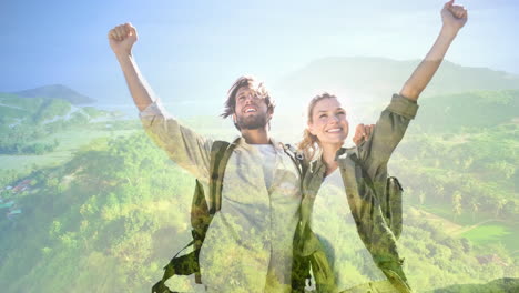 couple lifting hands in the mountains