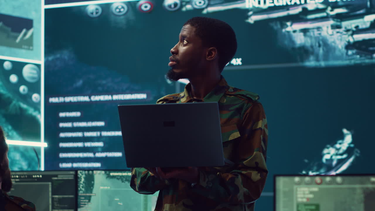 Infantry unit leader examines big data on a screen in military monitoring room