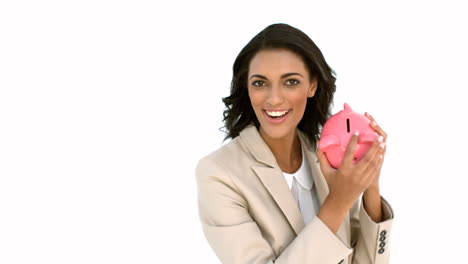 businesswoman catching piggy bank