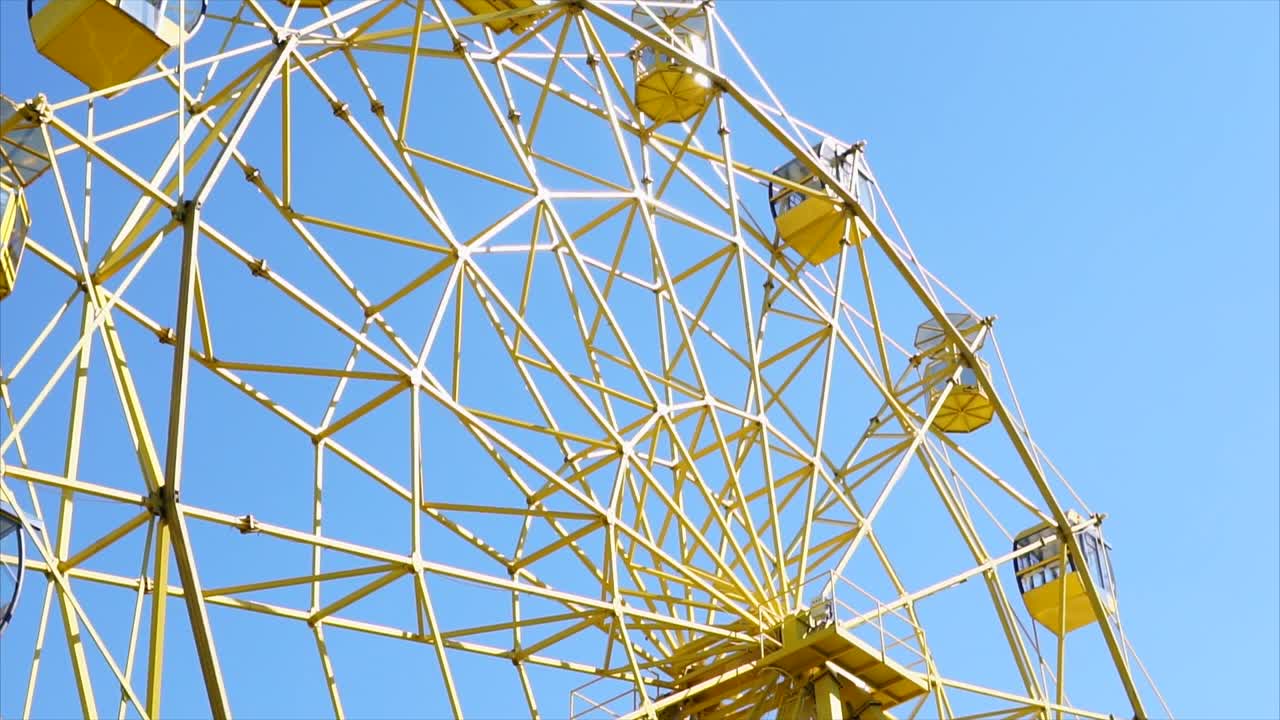 Yellow Ferris Wheel Against a Blue Sky