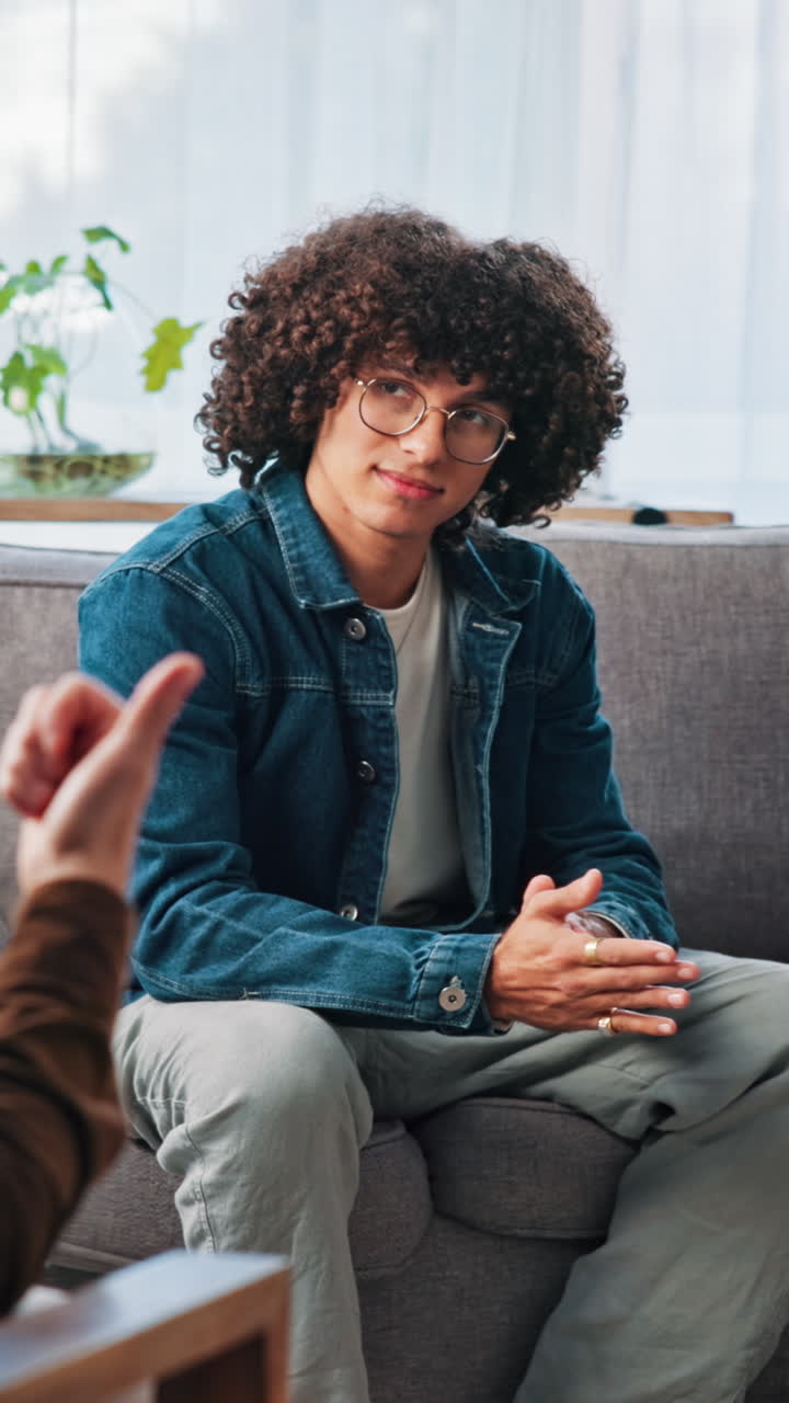 Young Man and Woman Having a Serious Conversation on a Couch