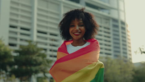 woman proudly displaying a rainbow flag