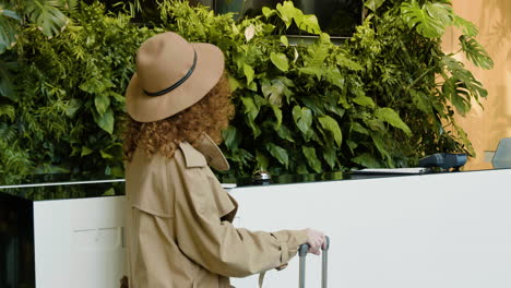 Back-view-of-redheaded-guest-waiting-in-the-reception