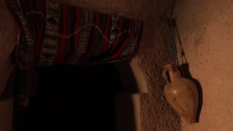 ancient tunisian house interior with traditional decor and earthen walls, warm lighting at dusk
