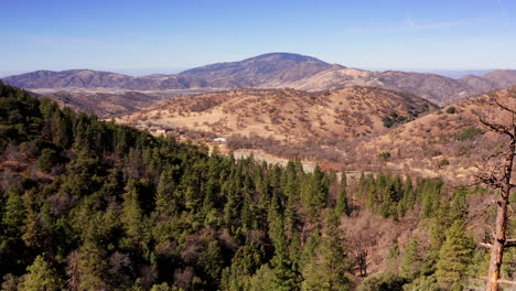 the evergreen forest on the tehachapi mountains transitions into the arid landscape of the mojave desert - aerial view