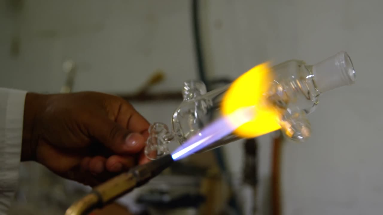 Close-up van mannelijke werknemer die glas maakt in glasfabriek 4k