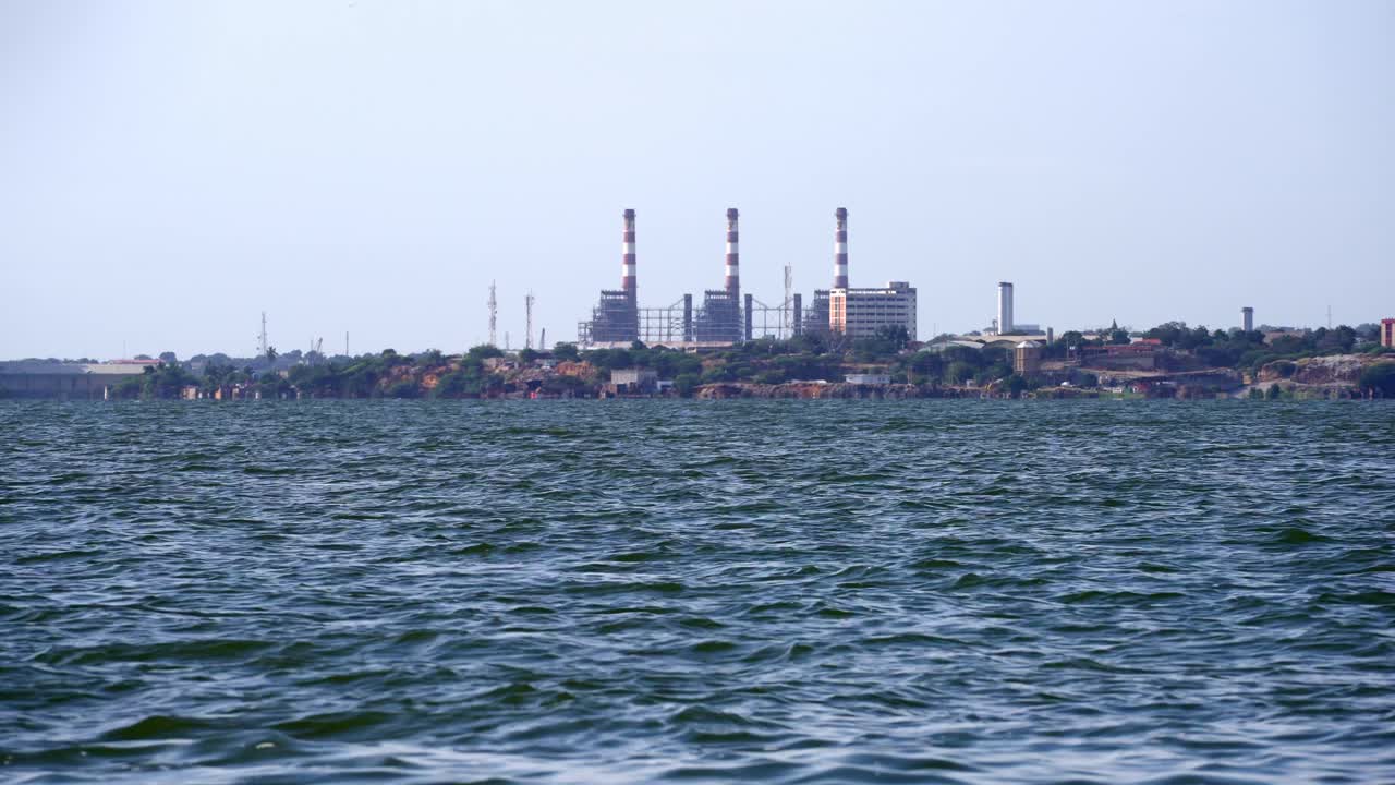 General wide view of an Oil Industry Facility on the shore of a polluted lake