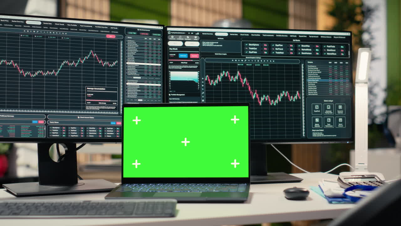 Stock market metrics diagrams displayed on green screen laptop in office