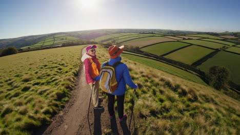 two hikers overlooking a vast patchwork landscape