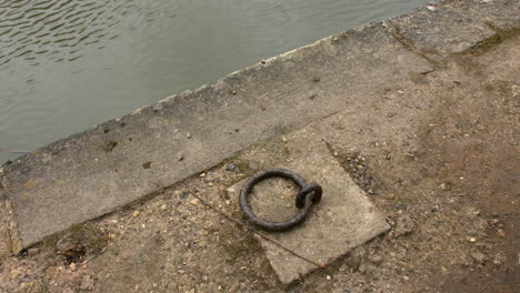 a canal boat mooring ring next to the river