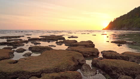 Gorgeous-Sunset-at-Tropical-Island-with-Rocky-Beach,-Orange-Sky