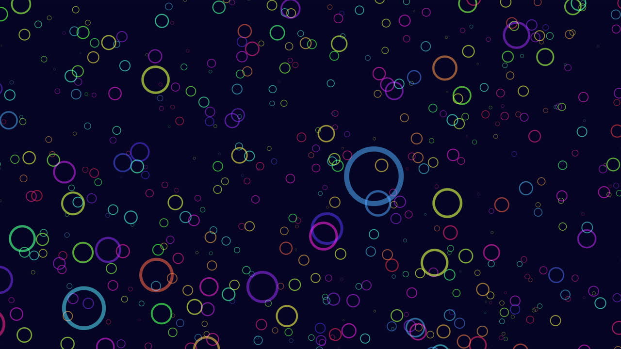 Colorful circles arranged in a symmetrical pattern on a black background, with the largest circle in the center surrounded by smaller ones, creating a visually appealing and intriguing composition
