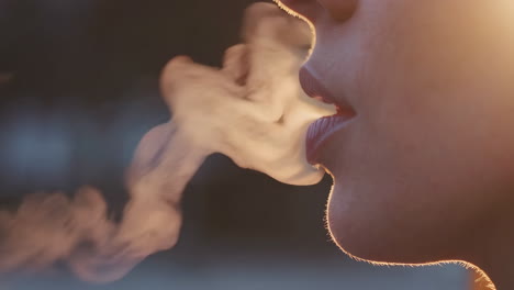 close-up of a person exhaling a large cloud of vapor