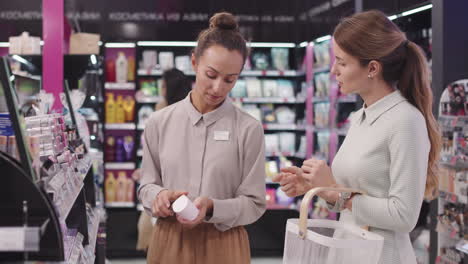 shop assistant suggesting products in cosmetics store