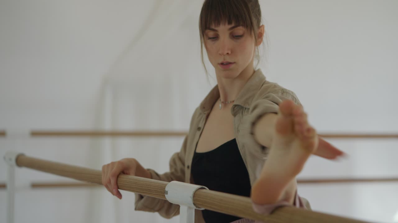 Ballet dancer stretching at the barre