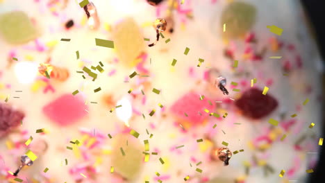 animación de confeti cayendo sobre dulces de colores y salpicaduras, creando una atmósfera festiva