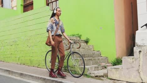 Mixed-race-man-walking-with-a-bike