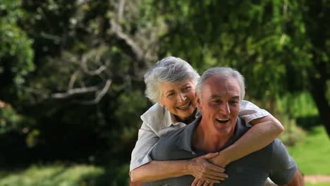 Seinor-man-carrying-his-senior-wife