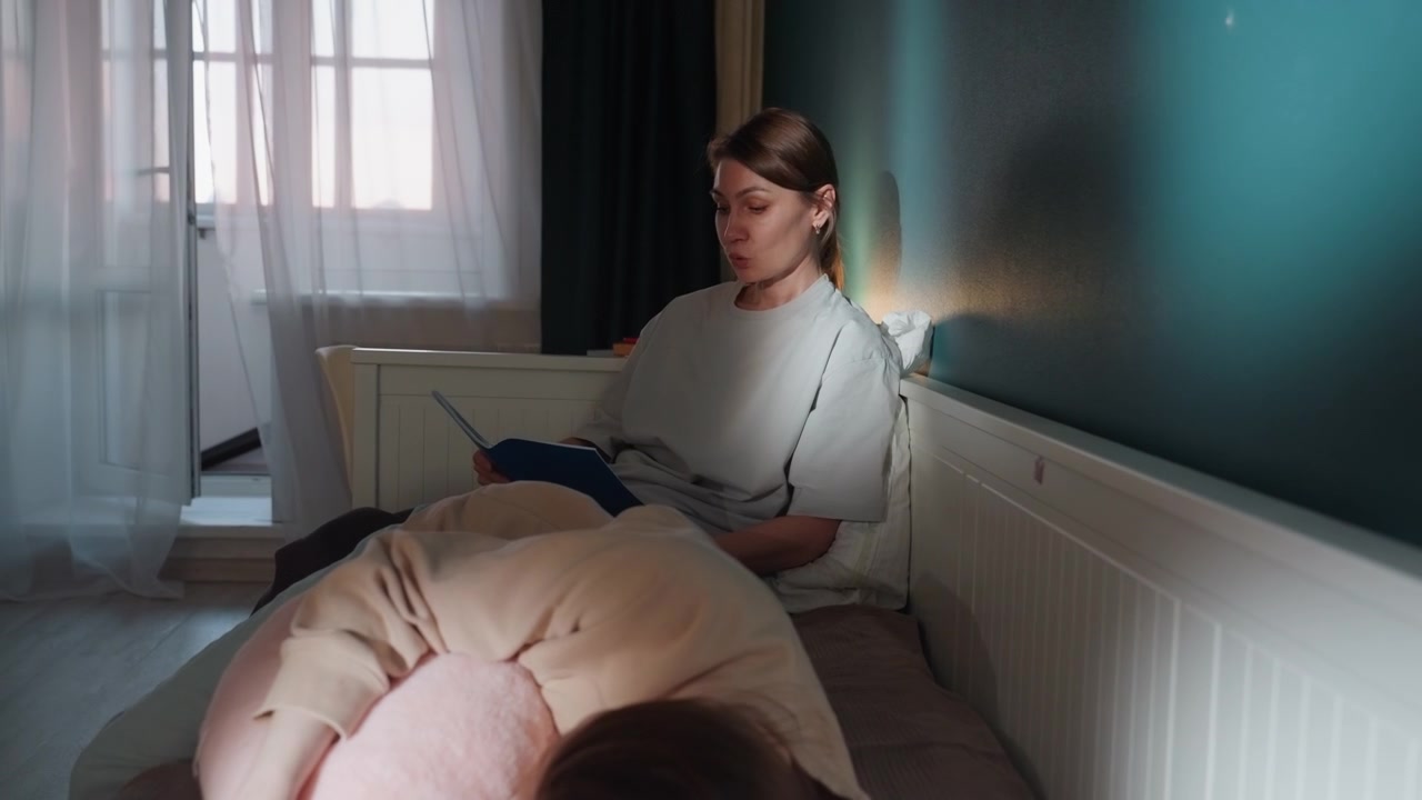 Caucasian tutor coaching child in bedroom, evening home lesson with female tutor guiding young student through grammar and reading exercises on bed, soft lamp glow, cozy interior, calm focused