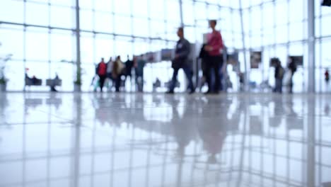 people walk inside a bright, modern building