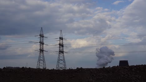 thick white smoke rises into the sky from an industrial chimney.