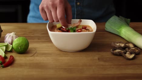 video of chef decorating the dish with shrimp and serving