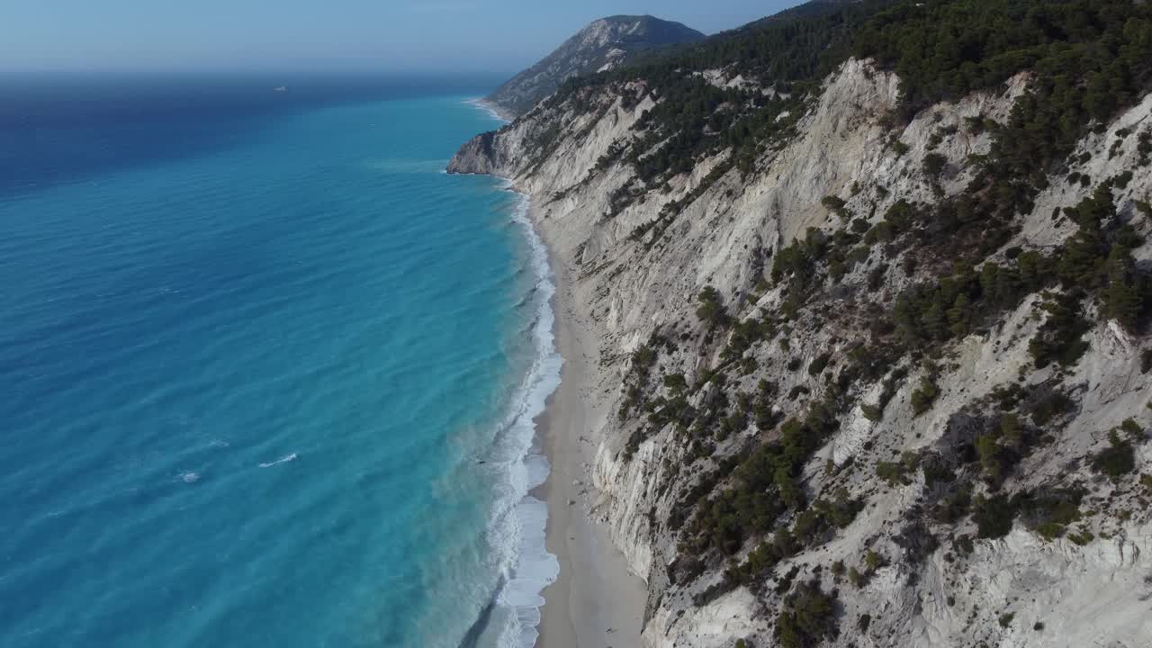 Fly by shot of the coastline and beach of Egremni, most popular tourist location in Lefkada, Greece