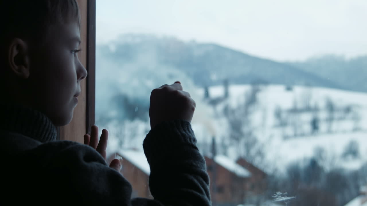 Silhouette Of Boy Draws On Window (Stock Footage)