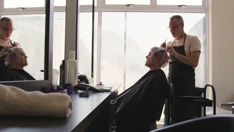 Distant-view-woman-having-her-hair-styled-by-a-hairdresser